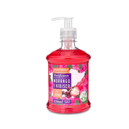 Frasco transparente com válvula pump, contendo sabonete líquido de cor rosa intensa. O produto é o Sabonete Glicerinado Purificante Premisse na fragrância Morango e Hibisco da linha Flores e Aromas. O rótulo vibrante, com desenhos de morangos e hibiscos, informa o volume de 450 mL e oferece 100 mL Grátis.